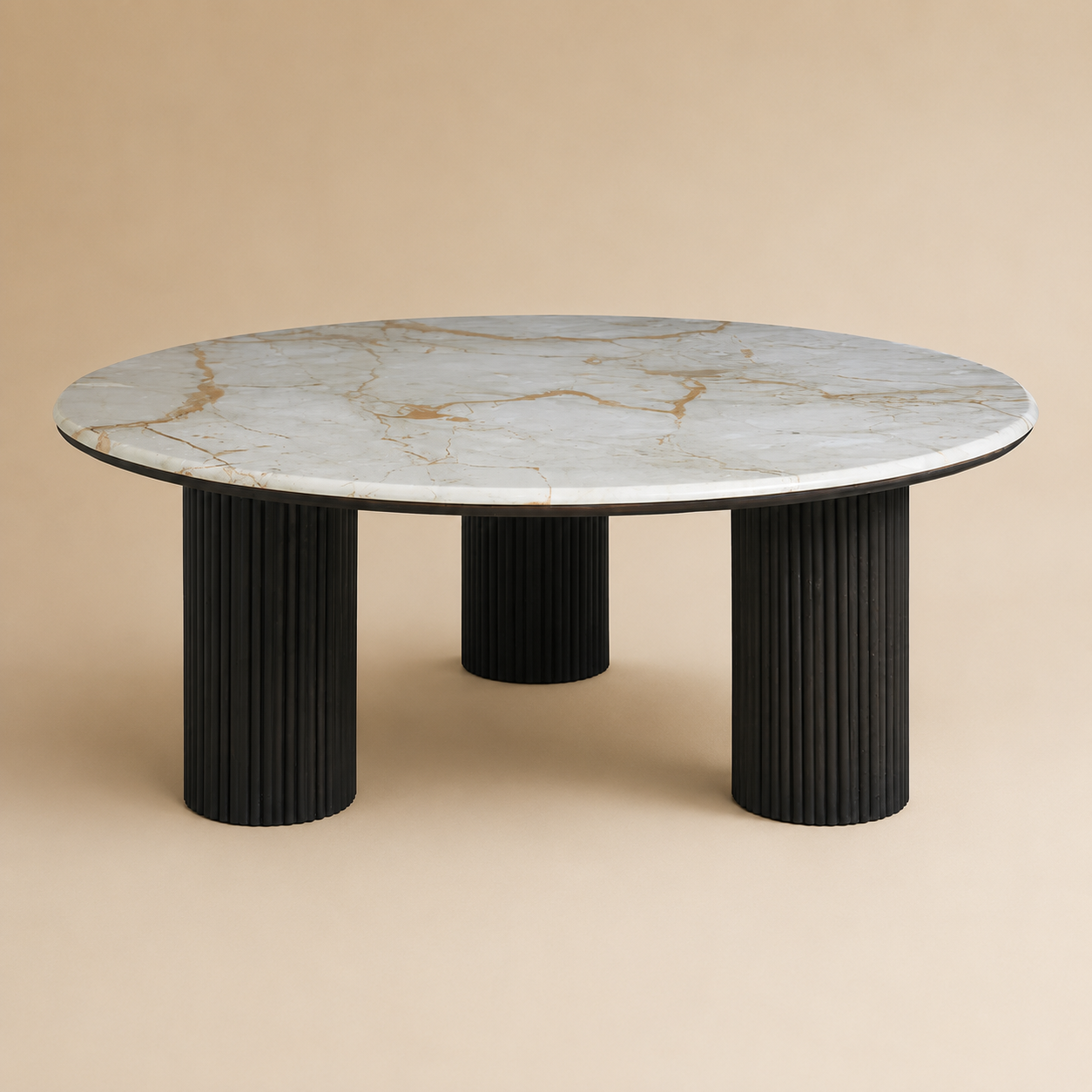 Round marble table with black cylindrical legs on a beige background