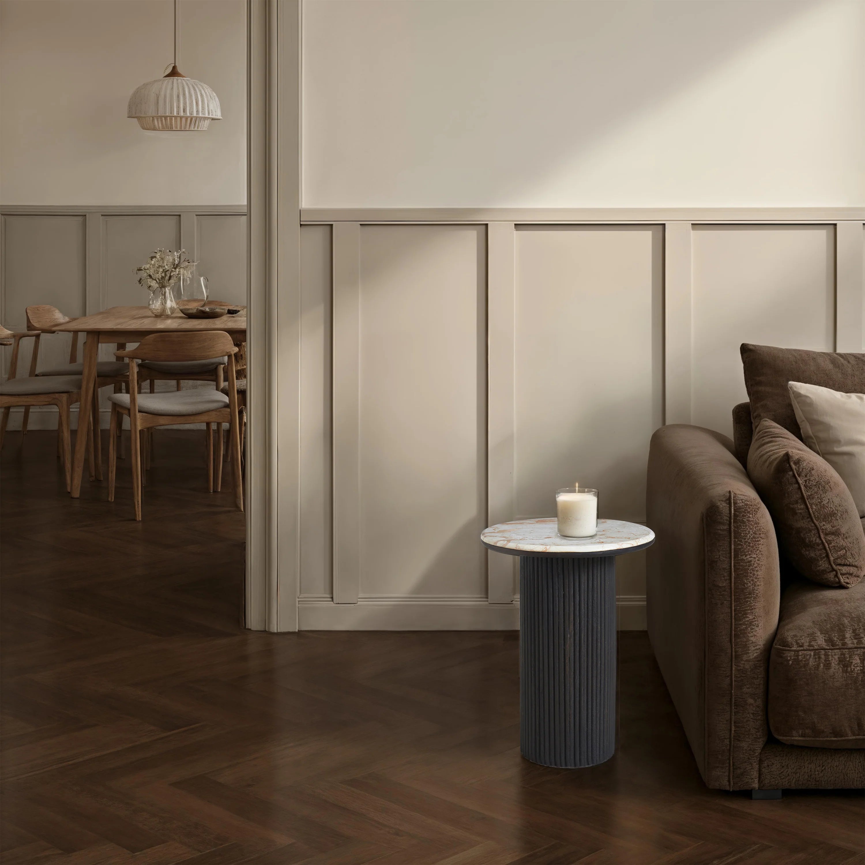 Living room with a sofa, side table, and candle