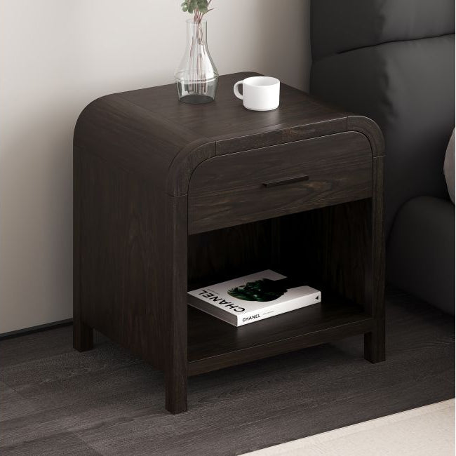 Dark walnut Eamon Nightstand styled beside a dark upholstered bed