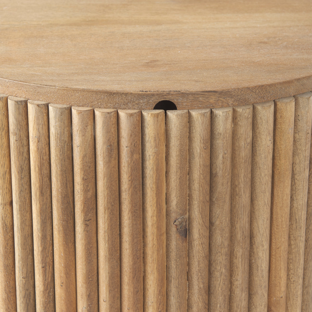 Close-up of the vertical fluted wood detailing and the smooth edge of the lid on the Eleanor mango wood side table.