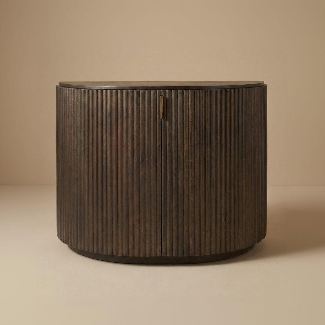 Full front view of the Eleanor dark mango wood accent cabinet featuring two fluted doors and a curved shape.