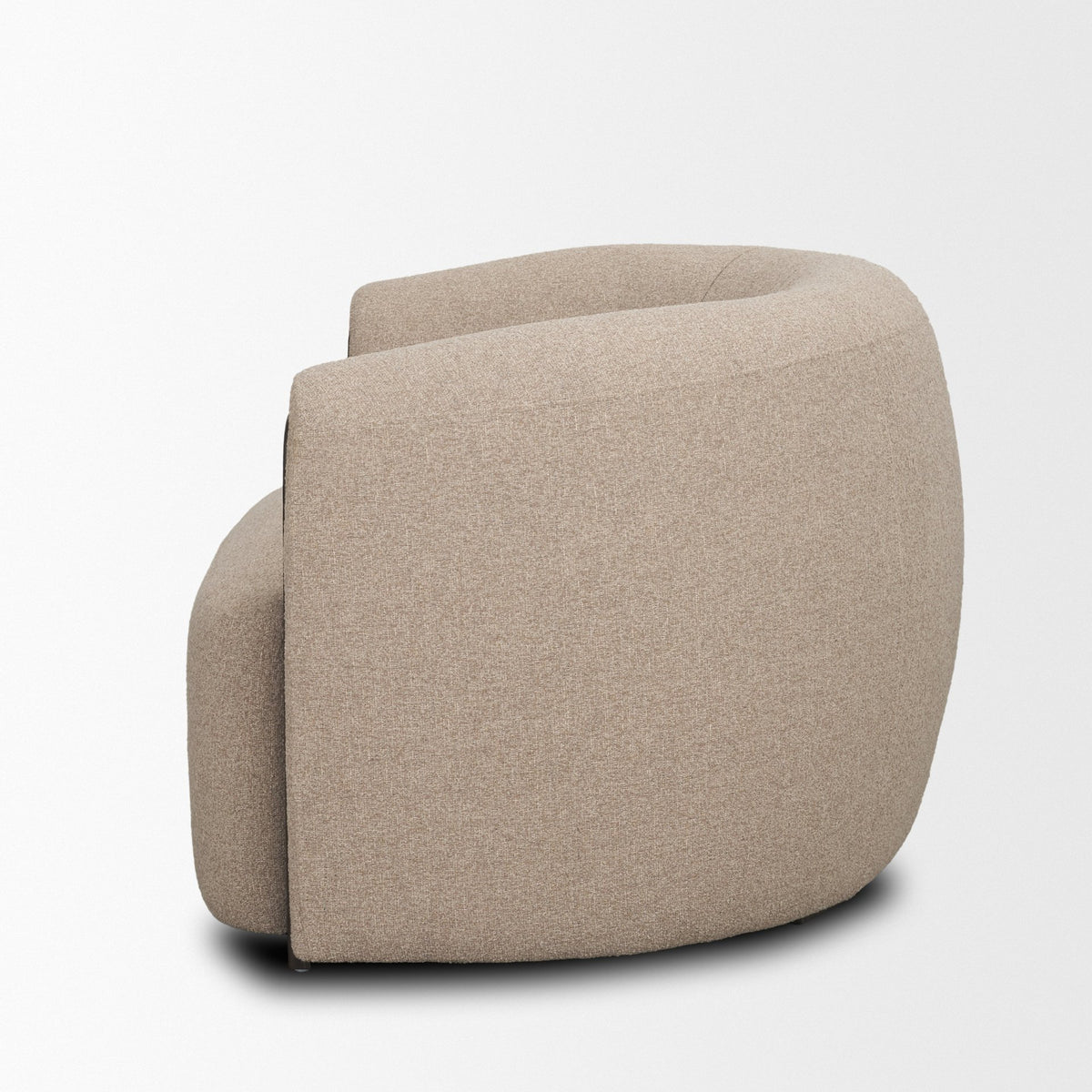 Side profile of the Elodie barrel chair against a white background, showing the wrap-around back and low-profile silhouette.