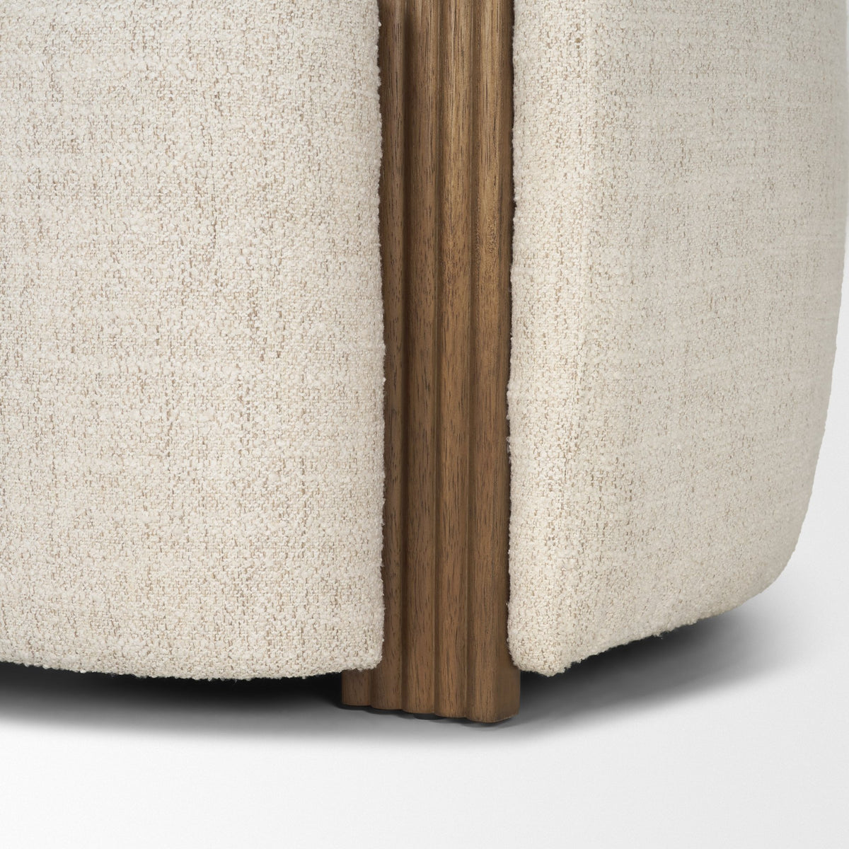 Detail shot showing the elegant integration of the fluted wood panel into the cream bouclé frame of the Elodie chair.