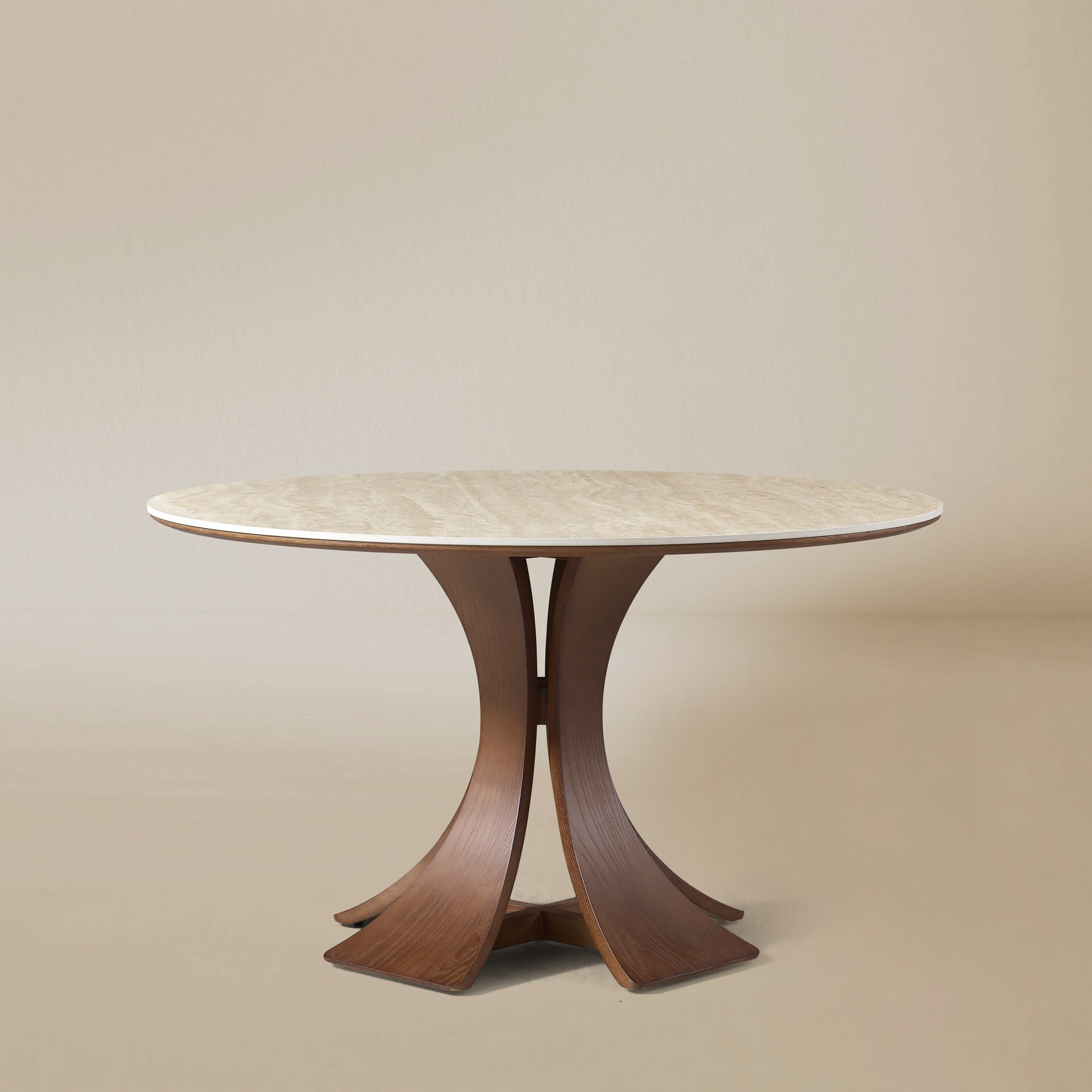 Elowen Round Dining Table with white top and sculpted walnut base against neutral beige background
