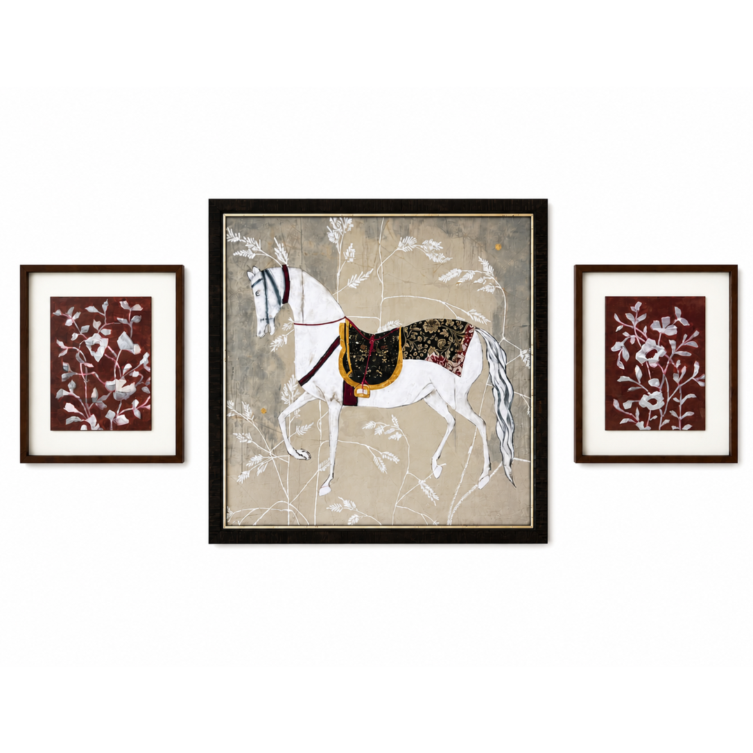 Three framed artworks on a wall, featuring a horse and floral designs.