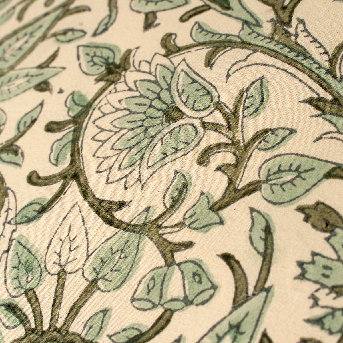Fern Block Print Pillow – close-up of a floral pattern with green leaves and brown stems on a beige background