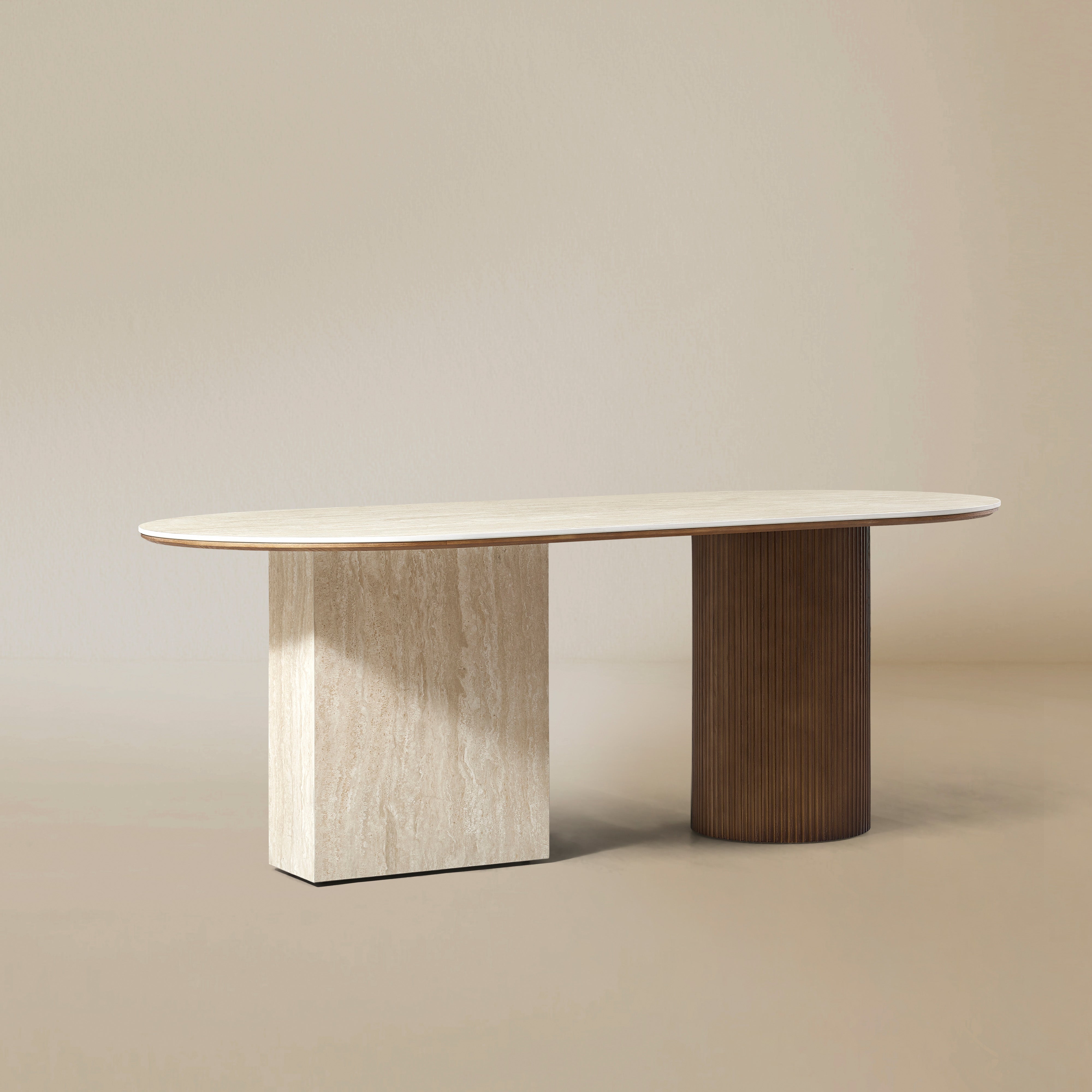 Gianna dining table with oval natural travertine top and dual wood pedestal base on beige studio background