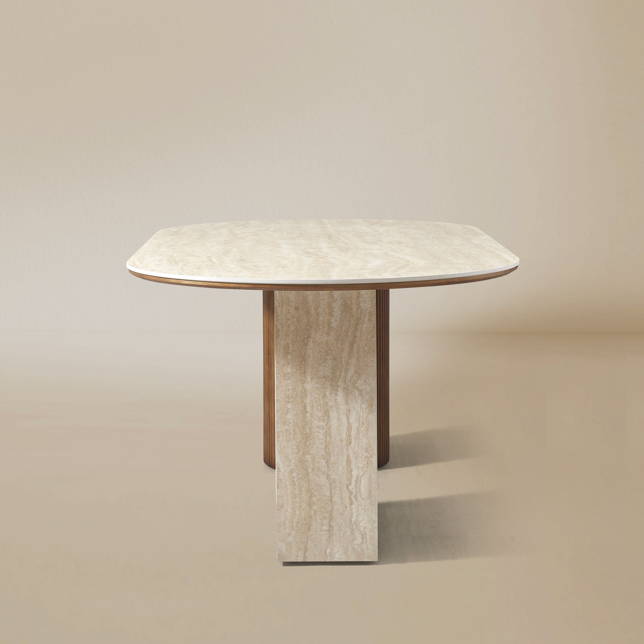 Natural Travertine side view of the Gianna dining table with oval top and dual wood pedestal base on beige studio background