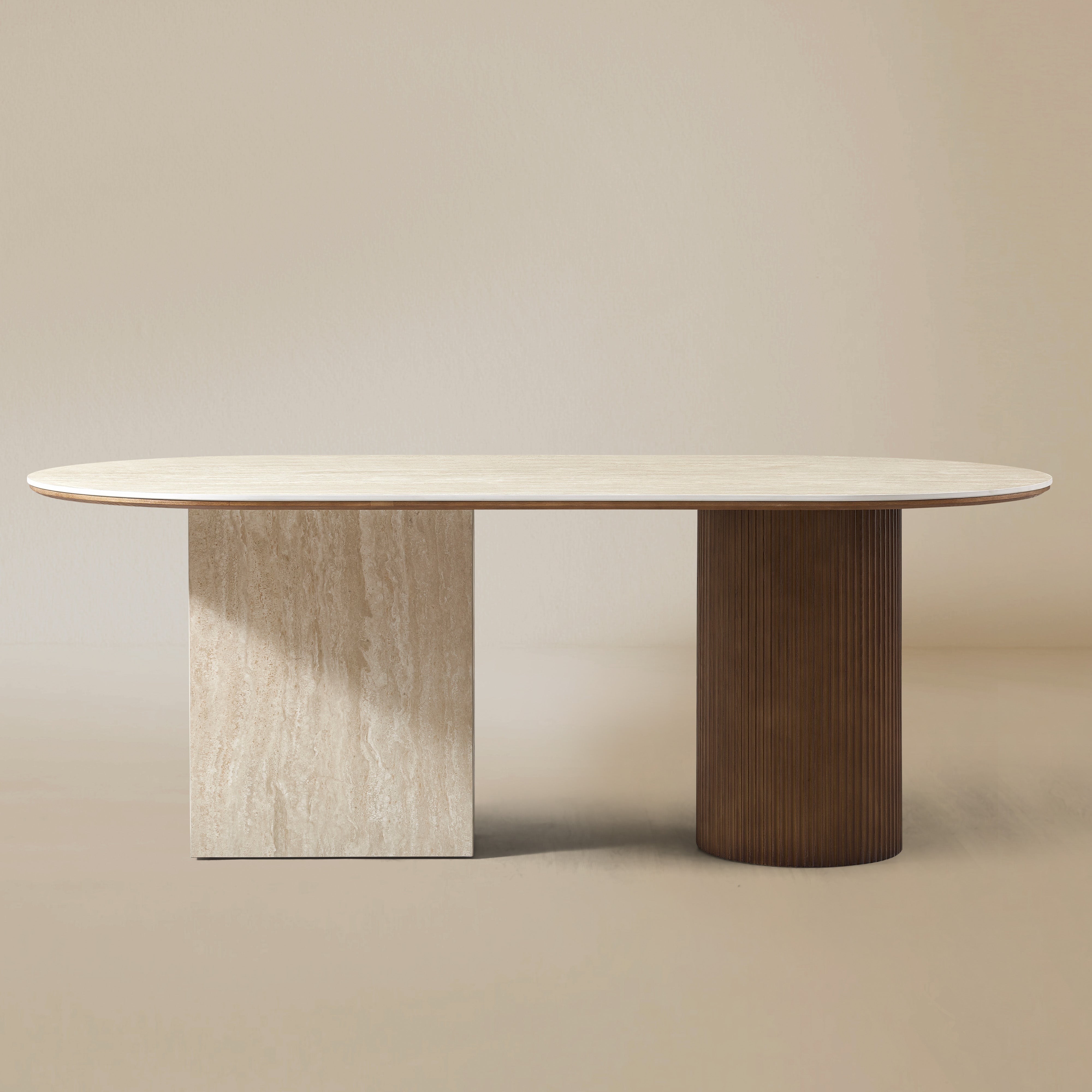 Gianna dining table with oval natural travertine top and dual wood pedestal base on beige studio background