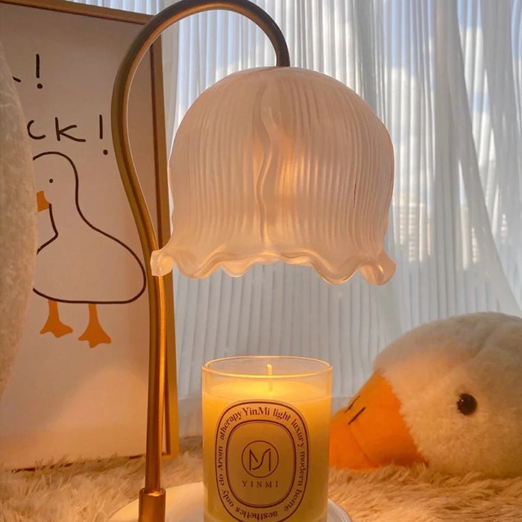 Glass Flower Candle Warmer Lamp on a cozy surface with a lit candle and soft plush decor.