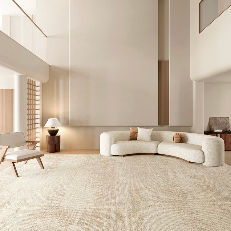 Grace Rug styled in a modern neutral living room with curved cream sofa, wooden accents, and soft beige textured pattern