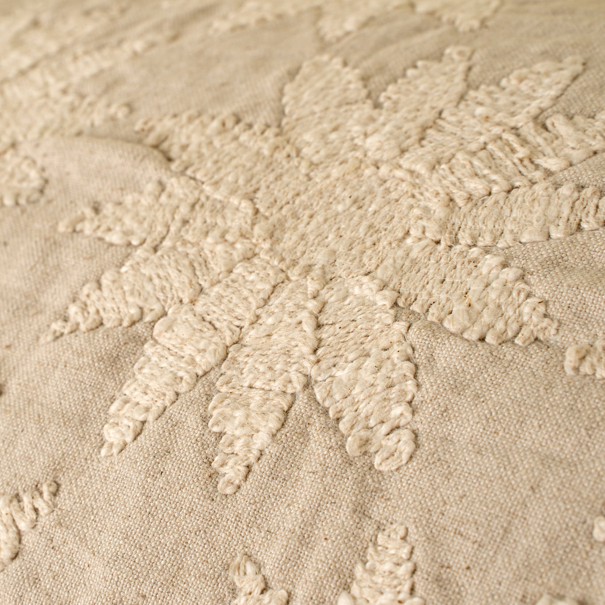 Close-up of textured beige fabric with floral patterns