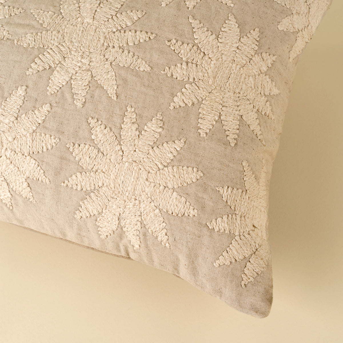 Decorative pillow with floral pattern on a beige background