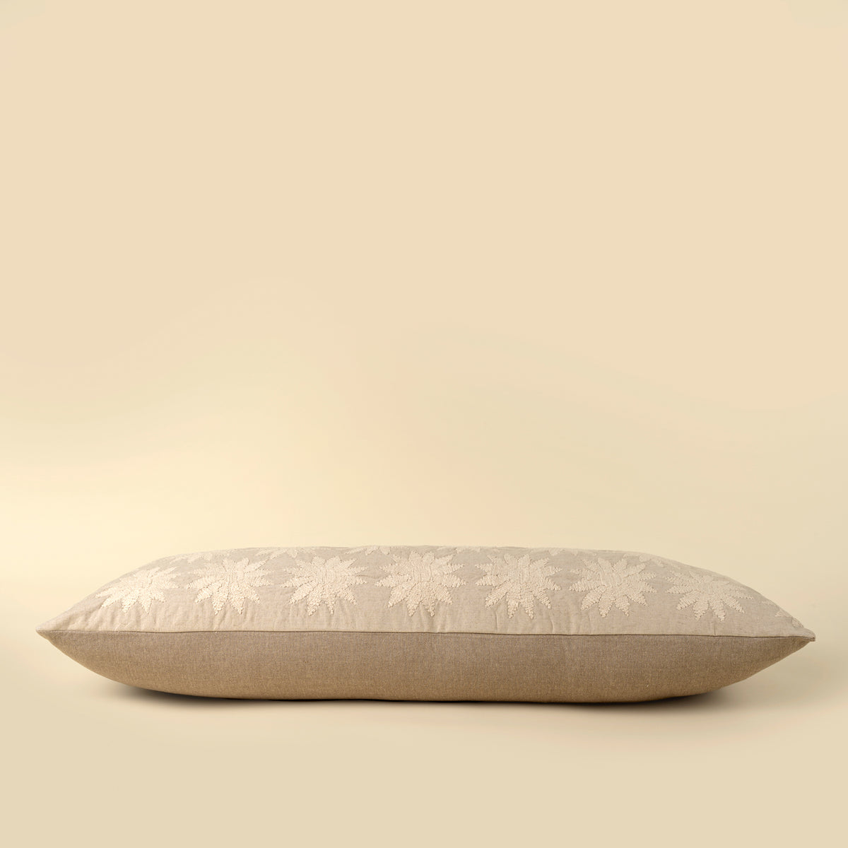 Decorative pillow with floral pattern on a beige background