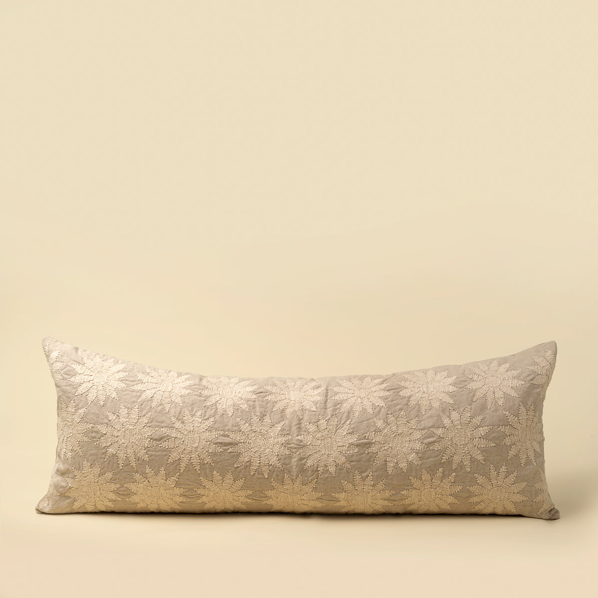 Decorative pillow with floral pattern on a beige background