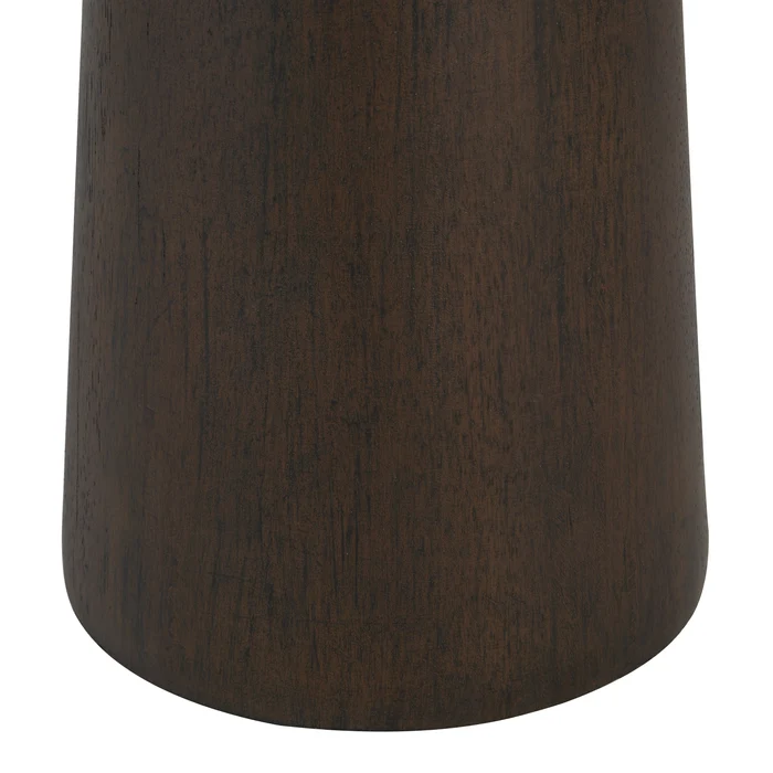 Close-up of the Inez floor lamp's tapered resin base in a painted dark walnut finish.
