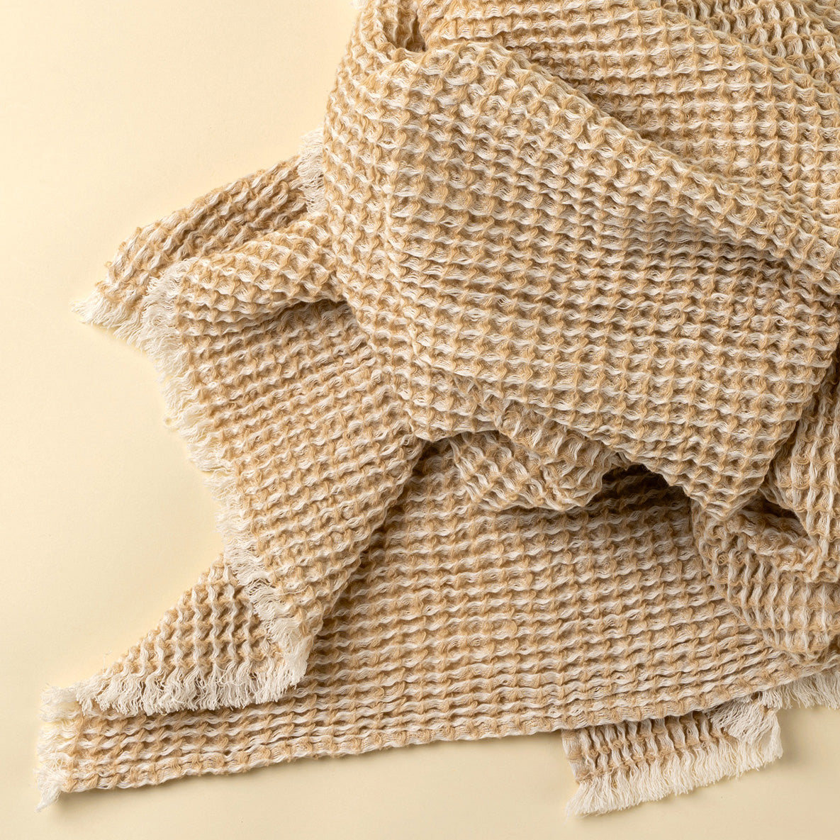 Beige textured blanket on a beige background