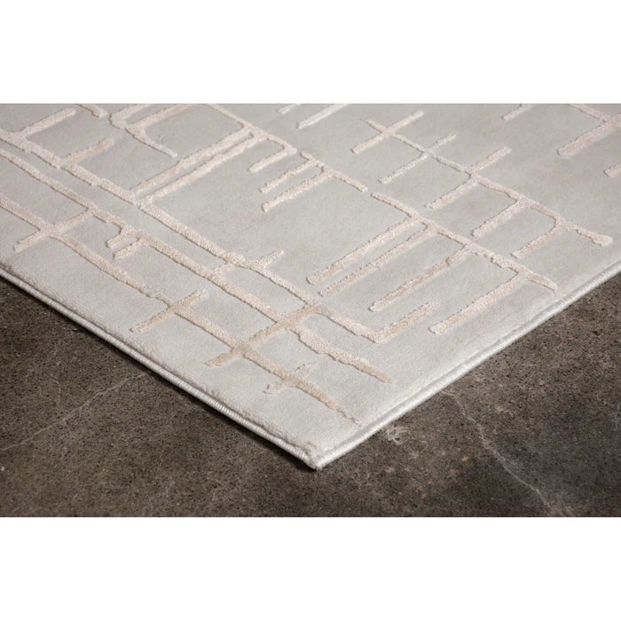 Gray rug with geometric pattern on a dark floor