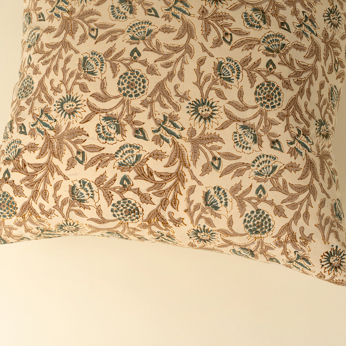 Decorative pillow with floral pattern on a beige background
