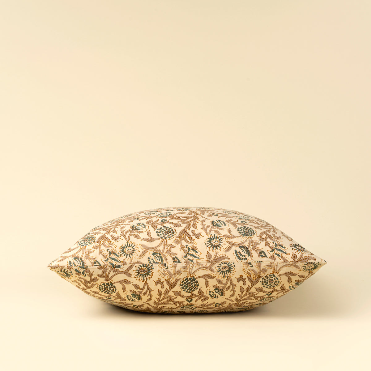 Decorative pillow with floral pattern on a beige background