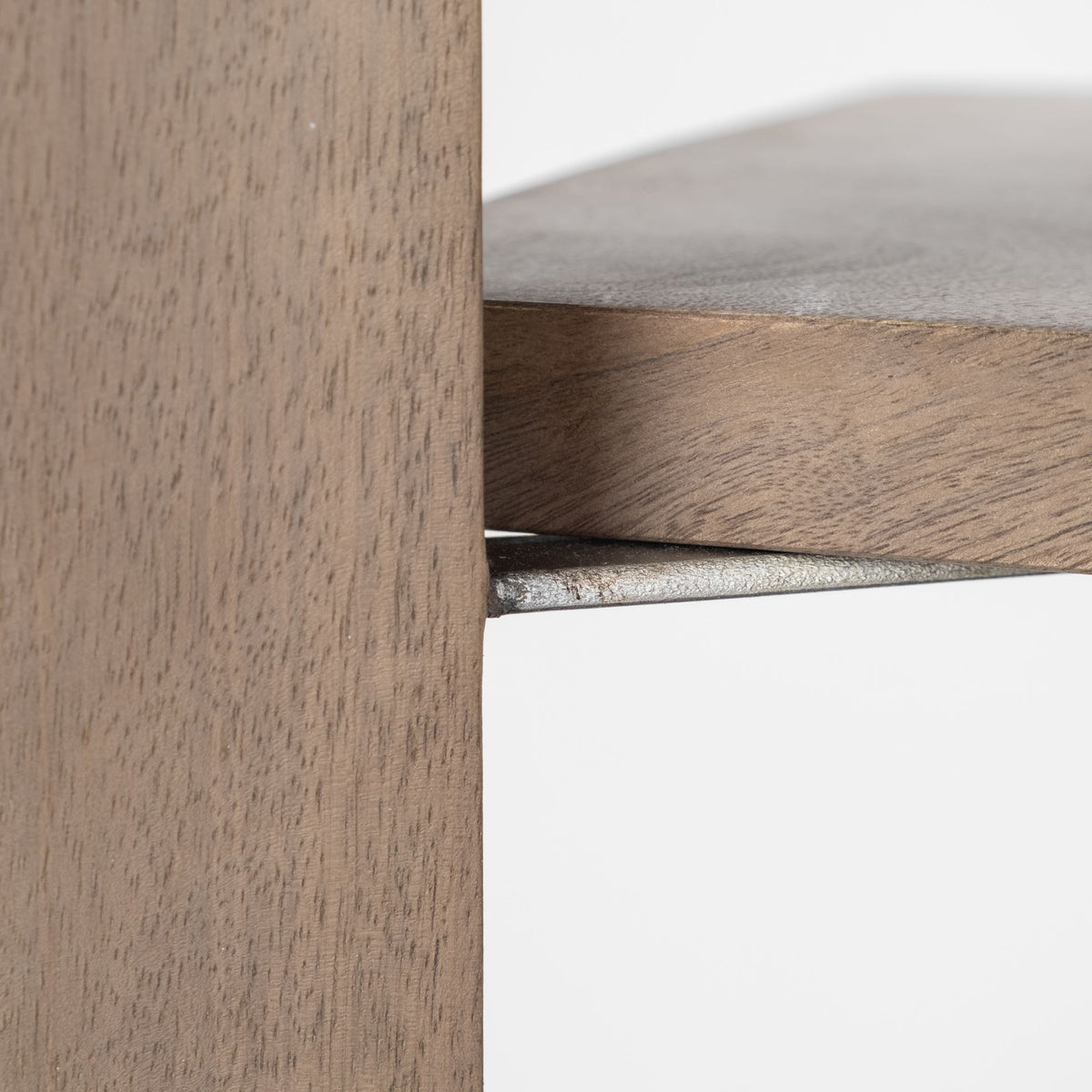 Close-up of the sturdy metal shelf bracket and natural wood grain on the Kade geometric shelving unit.