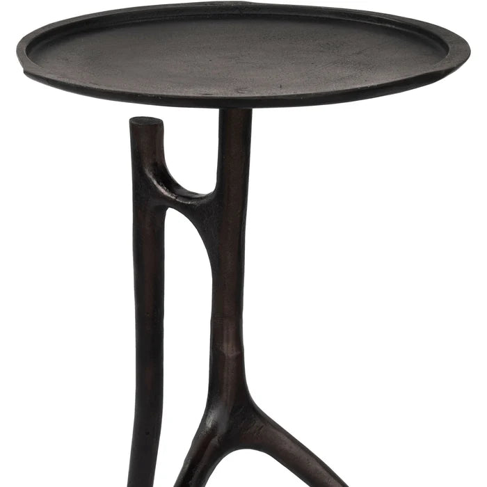 Black side table with a round top and unique base design on a white background