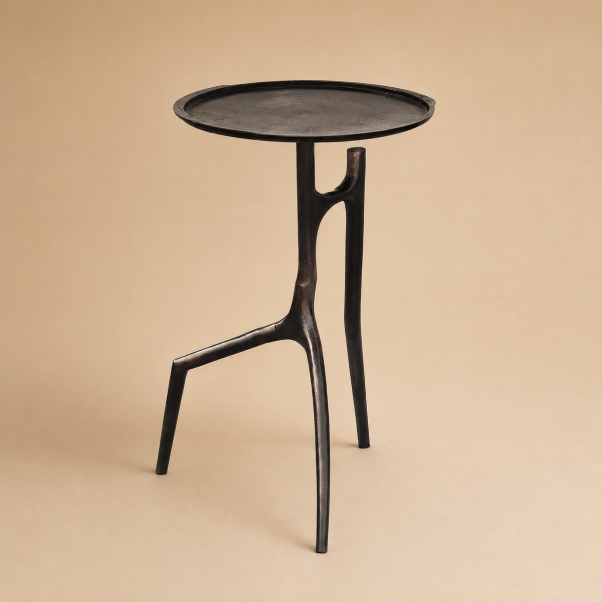 Black side table with a minimalist design on a beige background