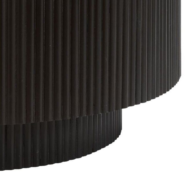 Black cylindrical base with fluted texture on a white background
