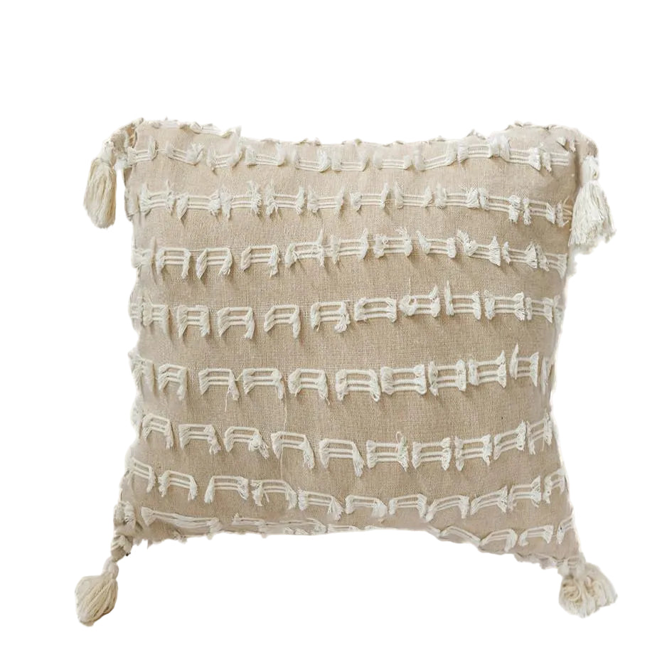 Textured pillow with tassels on a white background