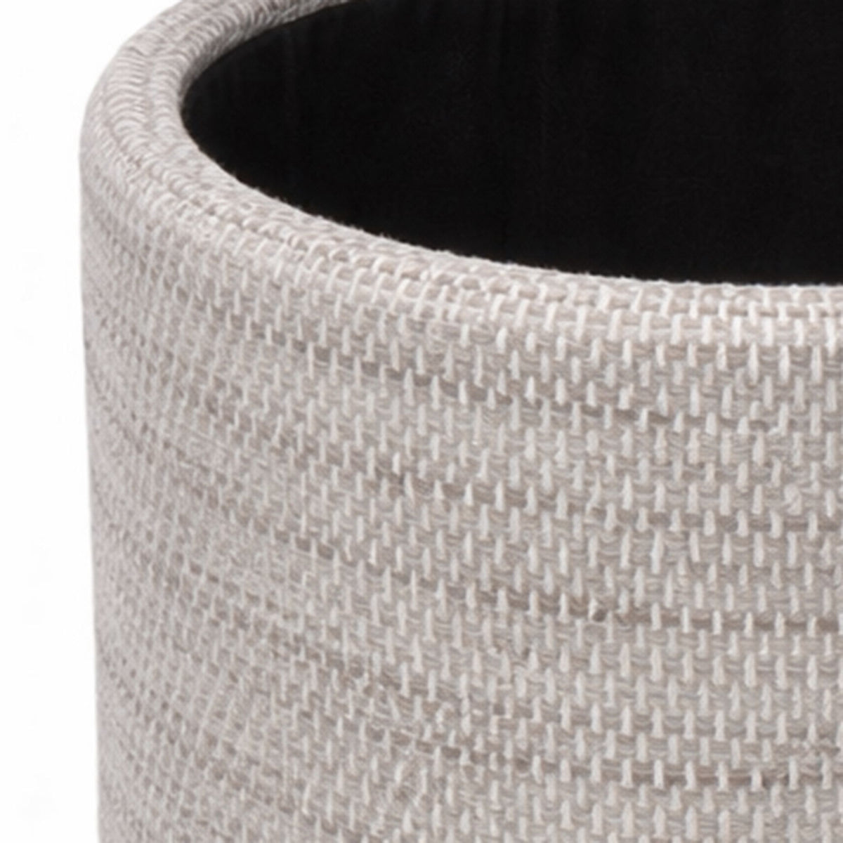Close-up of a textured gray planter with a black interior.