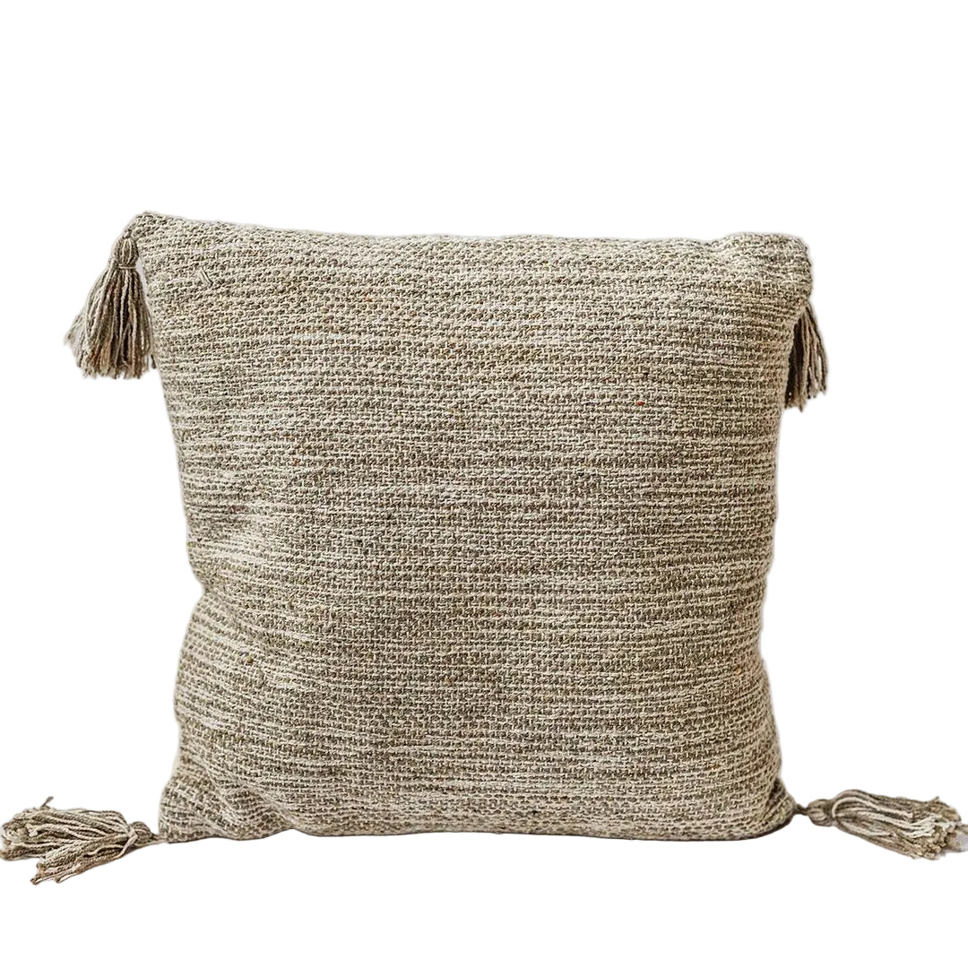 Textured pillow with tassels on a white background