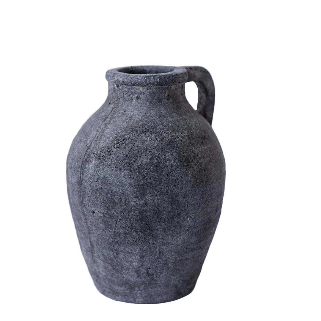 Dark gray textured vase on a light gray background