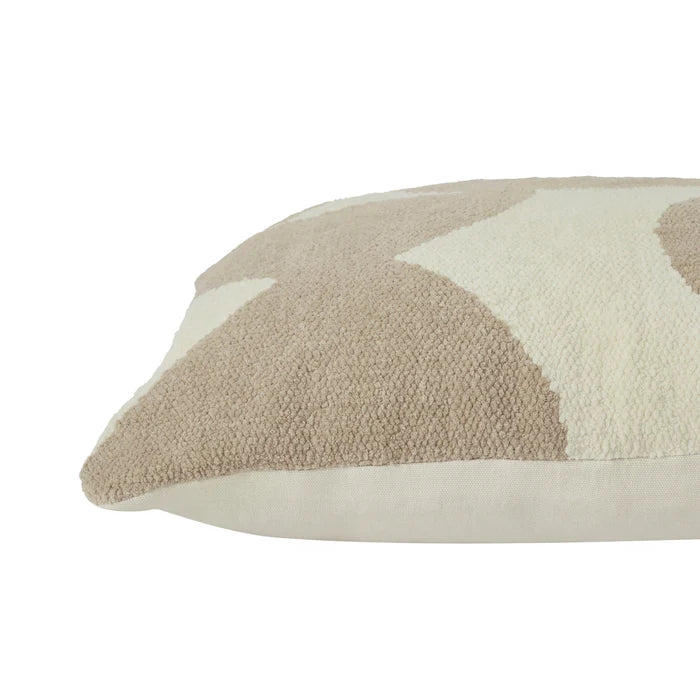 Close-up of a beige and white patterned pillow on a white background