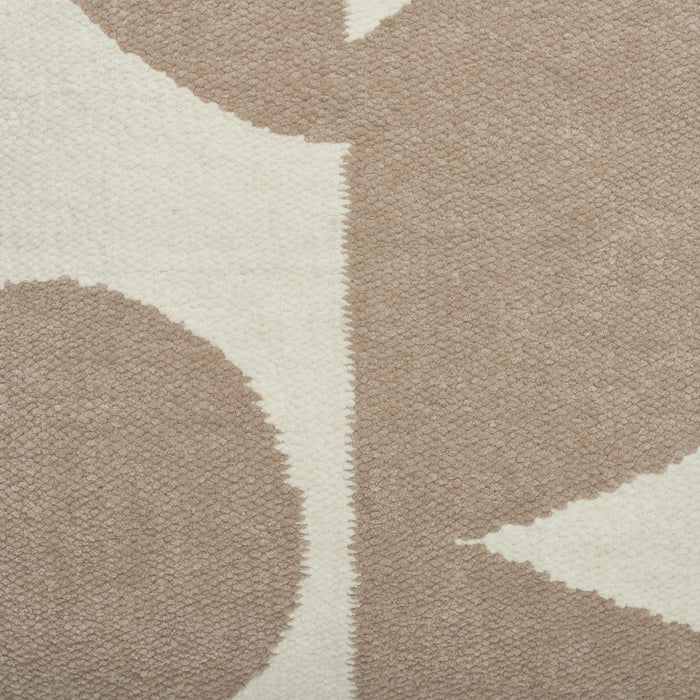 Close-up of a patterned rug with geometric shapes in beige and brown.