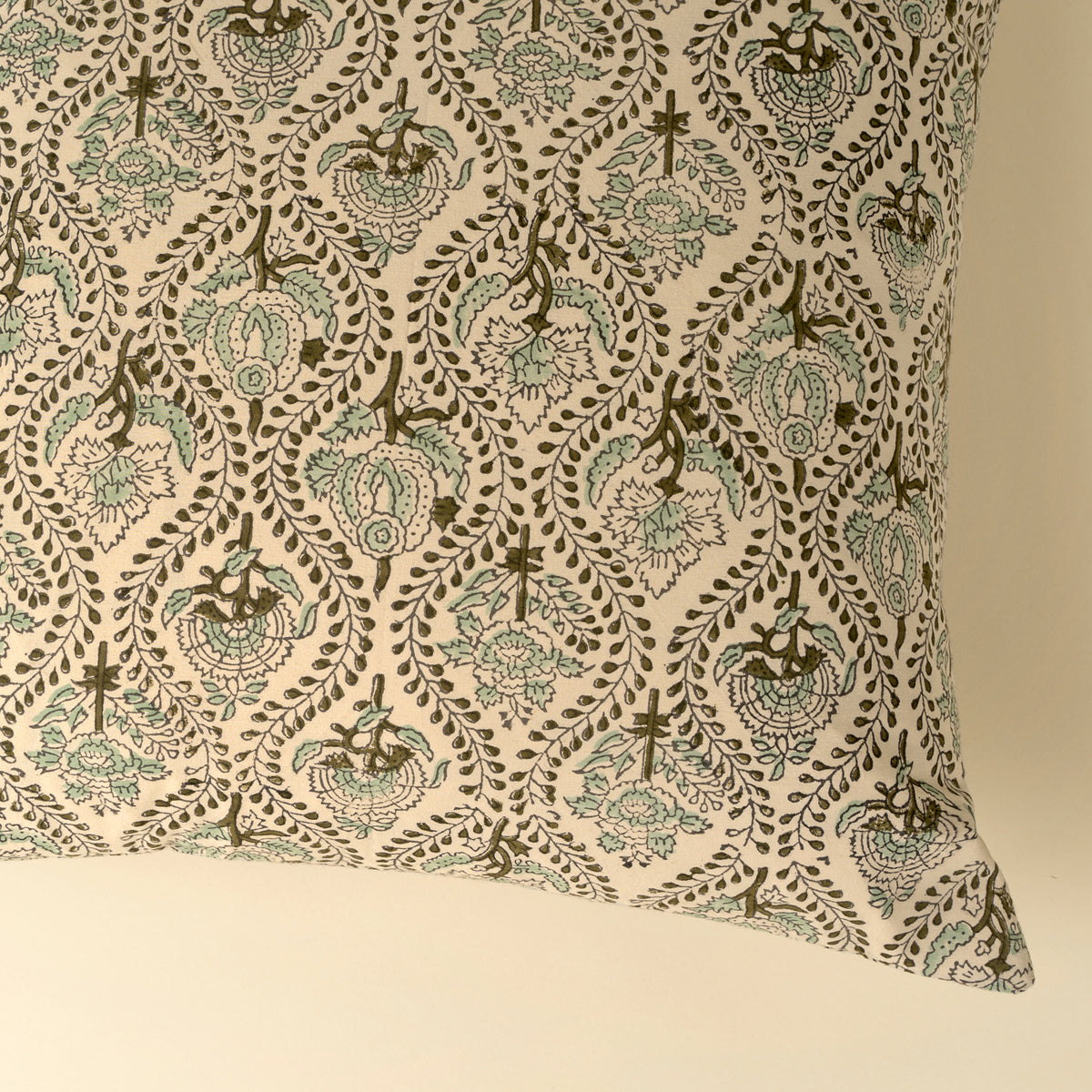 Decorative pillow with intricate floral pattern on beige background