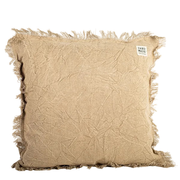 Textured beige pillow with frayed edges on a white background
