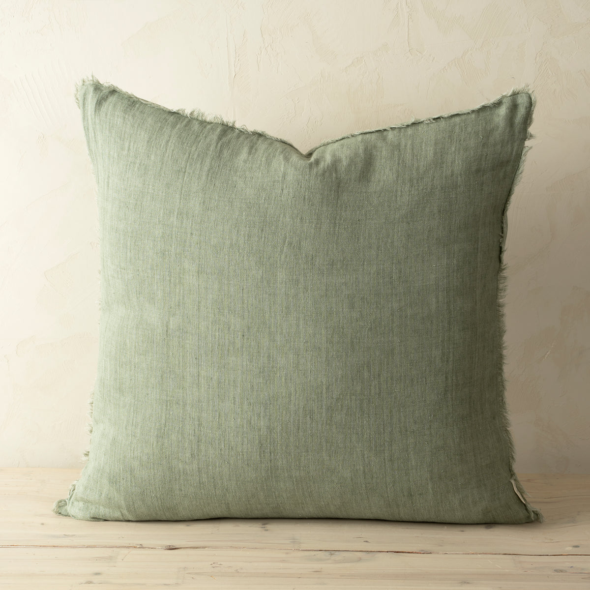 Full front view of the Lina linen pillow featuring a natural raw-edge fringe detail.