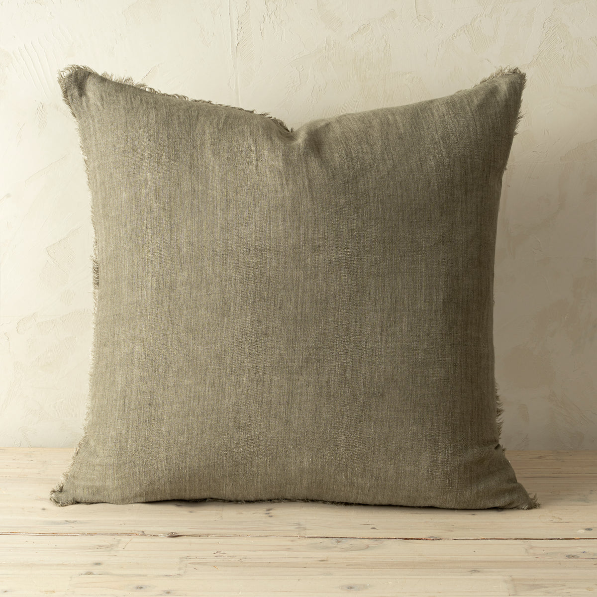 Full front view of the Lina linen pillow featuring a natural raw-edge fringe detail.