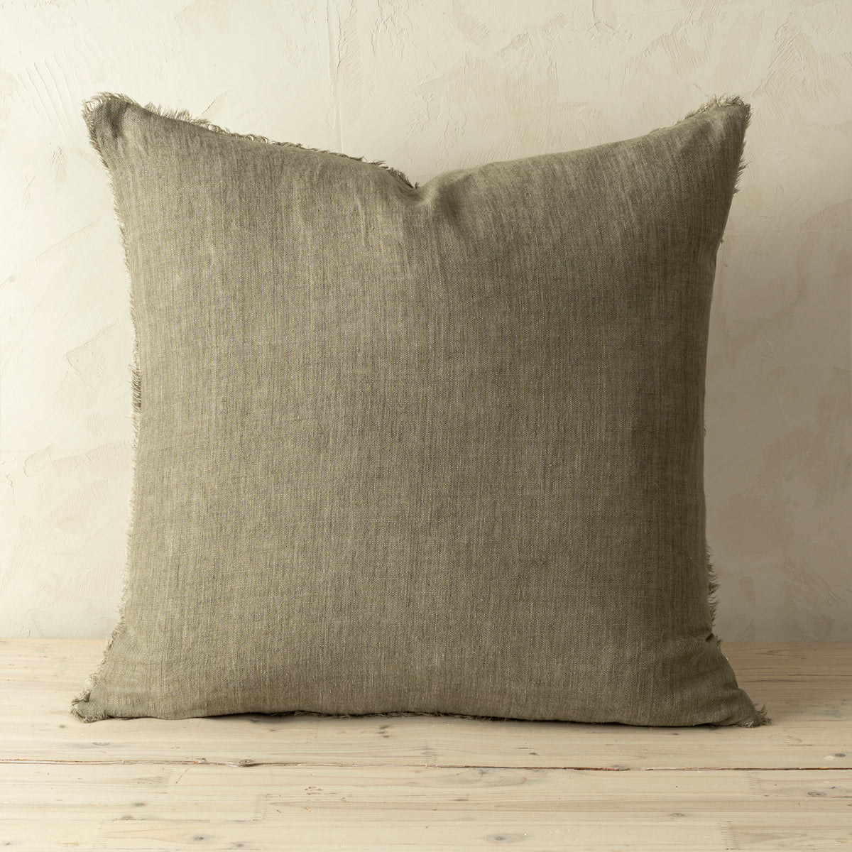 Full front view of the Lina linen pillow featuring a natural raw-edge fringe detail.