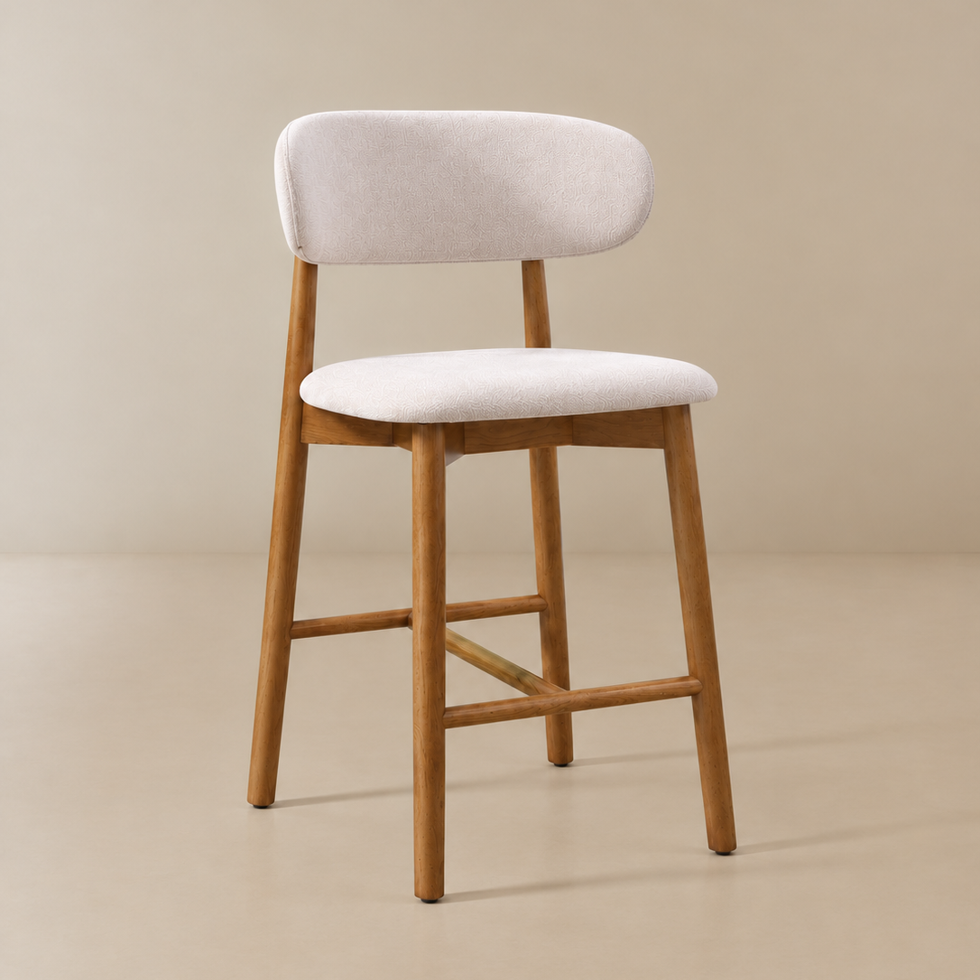 Angled front view of the Linen Ash Wood 26-inch Counter Stool with an ivory linen seat and back, natural ash wood legs and footrest.