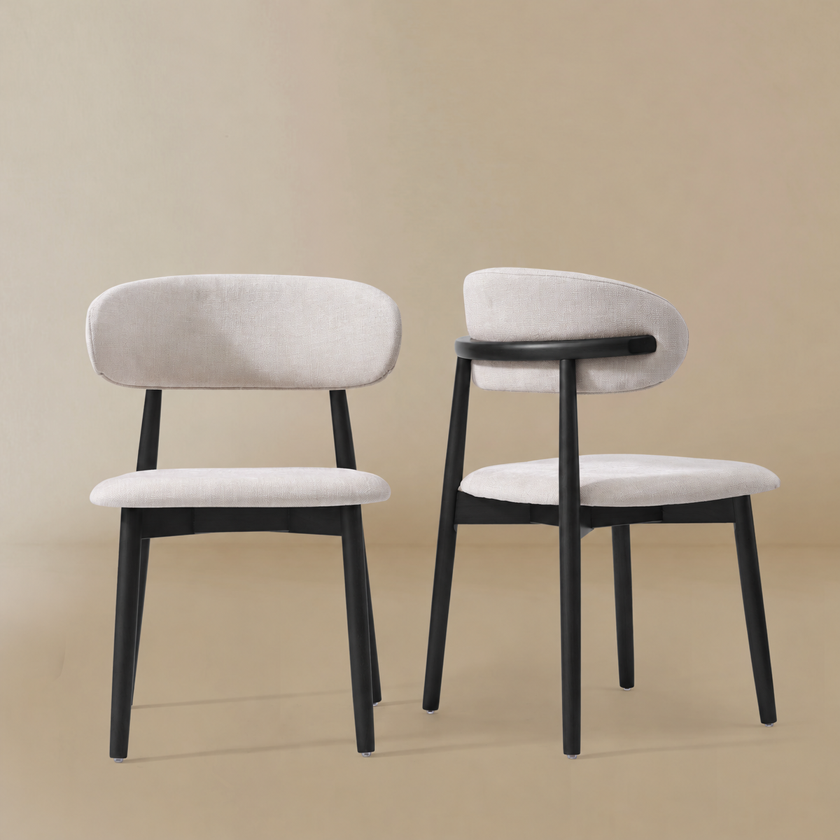Pair of Linen Elora Ash Wood Dining Chairs with black ash wood frames, shown in a neutral studio setting