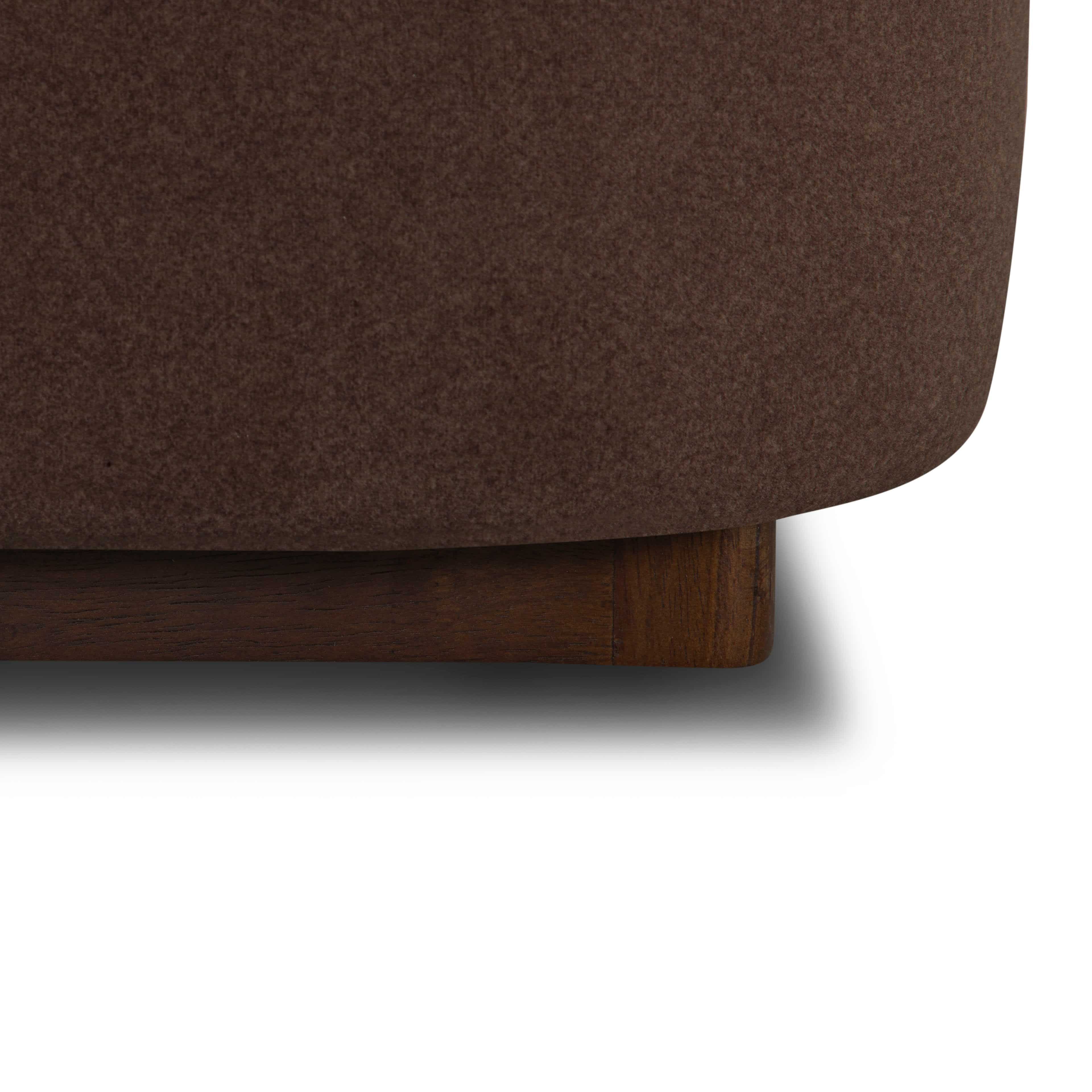 Close-up of the Lunelle Velvet Bed with a wooden base on a white background