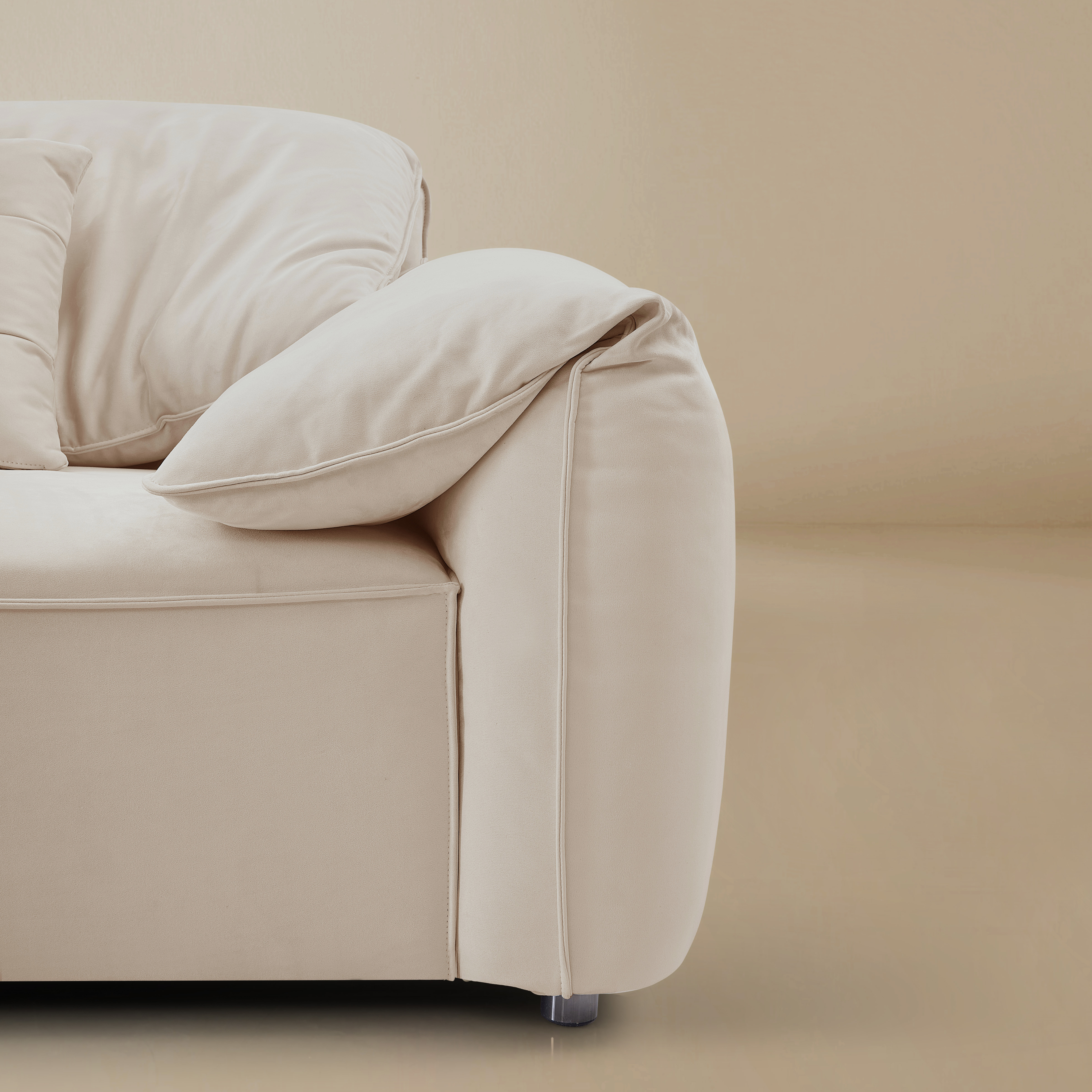 Beige sofa with a pillow on a beige background