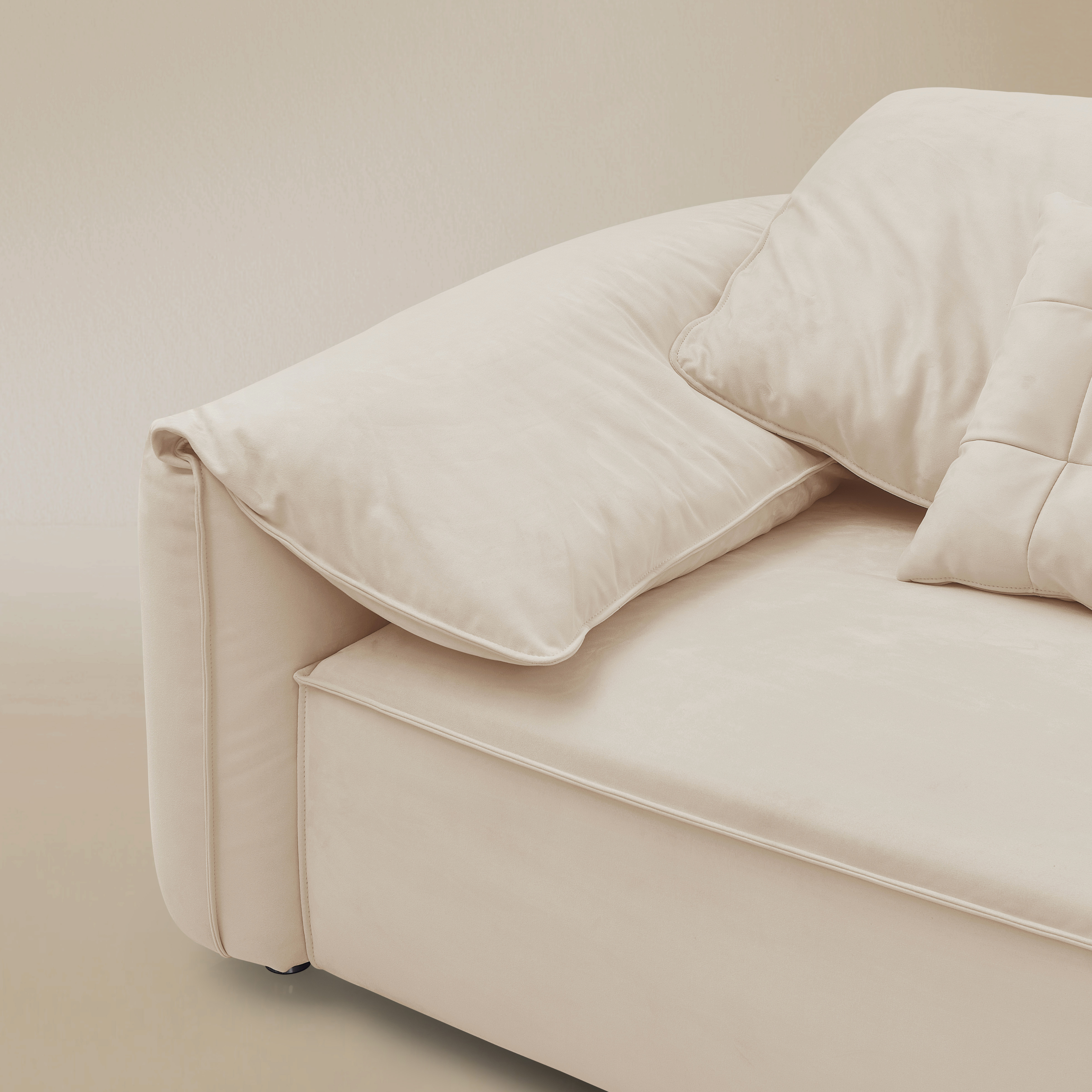 Beige sofa with cushions on a beige background