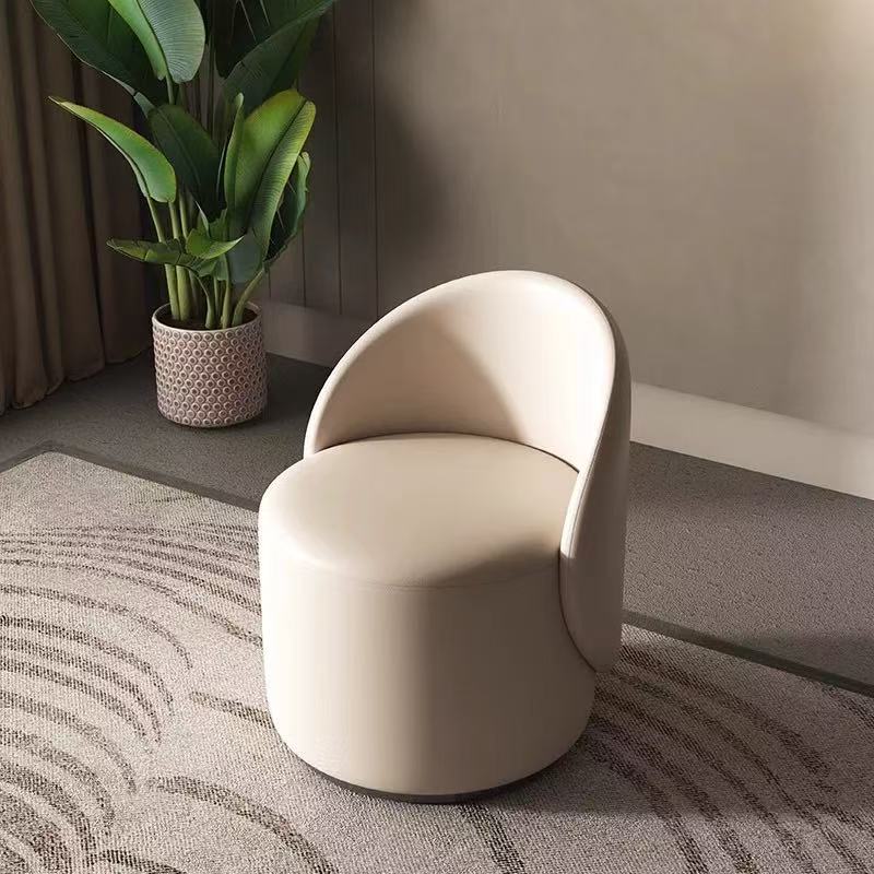 Curved vanity stool upholstered in beige vegan leather