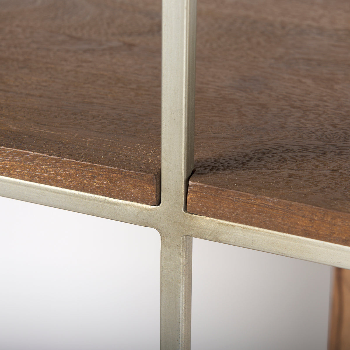 Close-up detail of the welded silver metal frame cross-sections on the Maddox geometric bookcase.