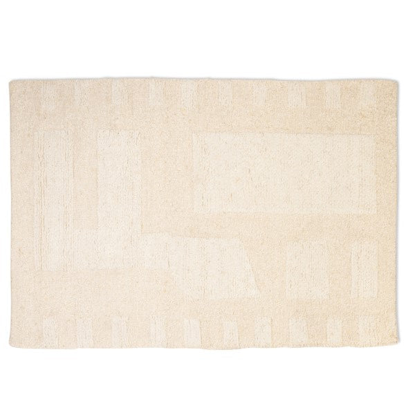 Full top-down view of the Maeve hand-woven wool rug in ivory, featuring a tonal abstract geometric pattern with textured block shapes
