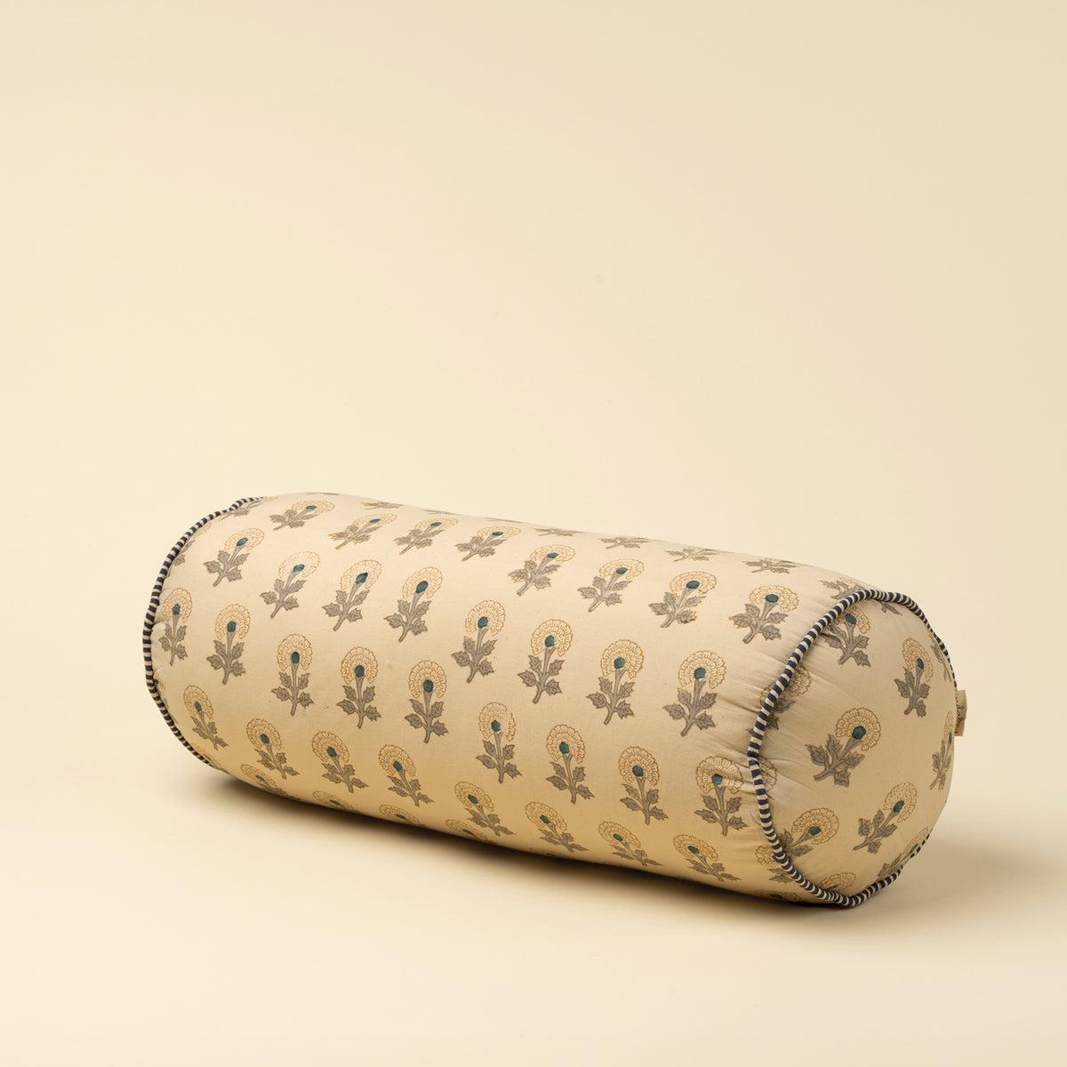 Decorative cylindrical pillow with floral pattern on a beige background