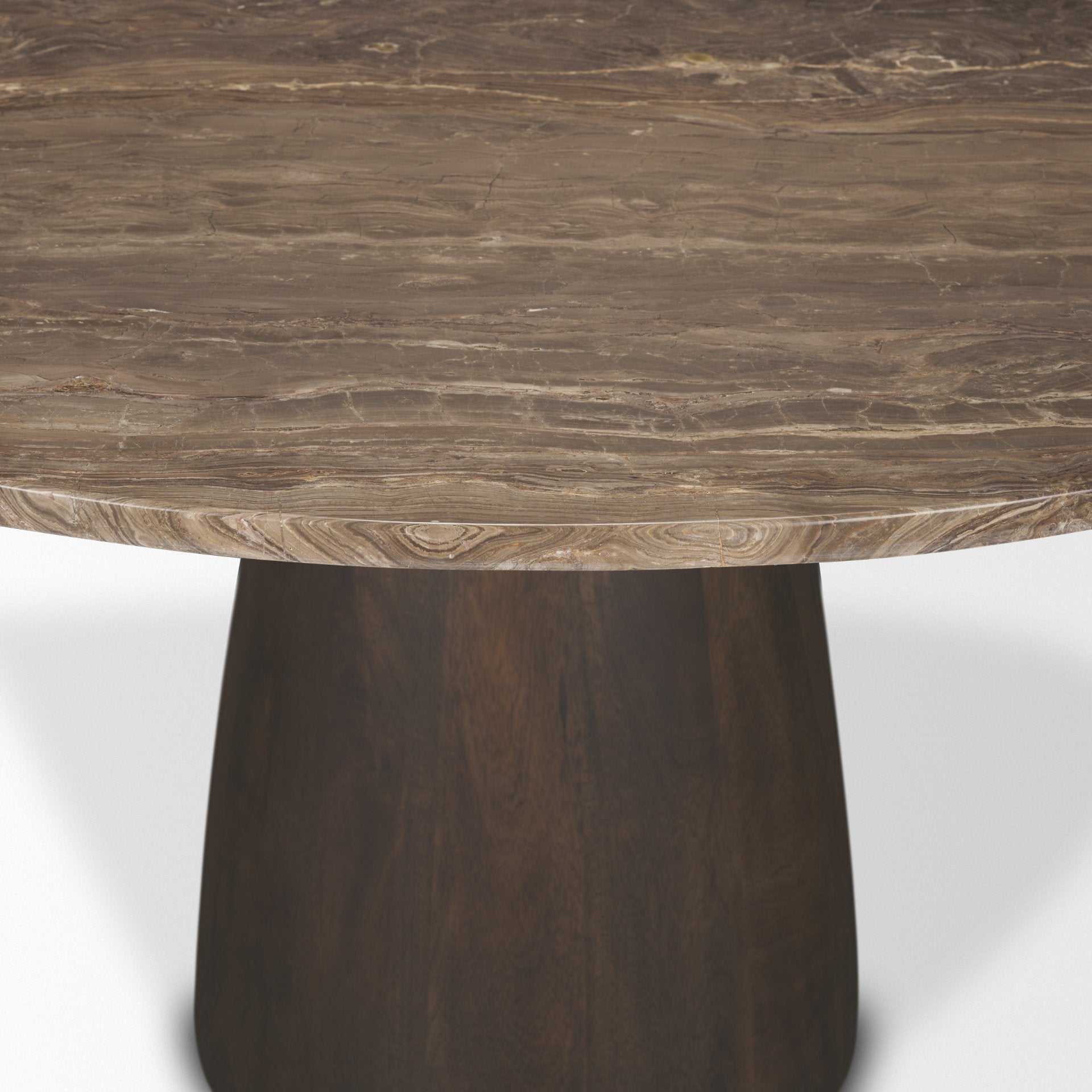 Studio close-up of the Mateo round table showing the polished edge of the marble top and the smooth finish of the wooden pedestal.