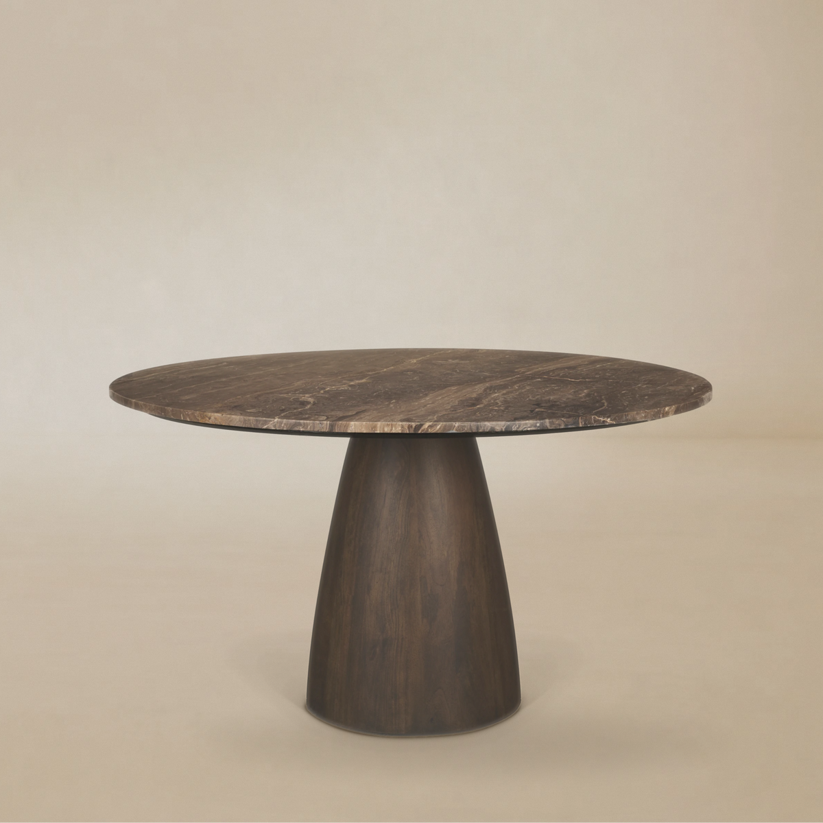 Full front view of the Mateo round dining table featuring a dark brown marble top and a tapered conical dark wood pedestal base.